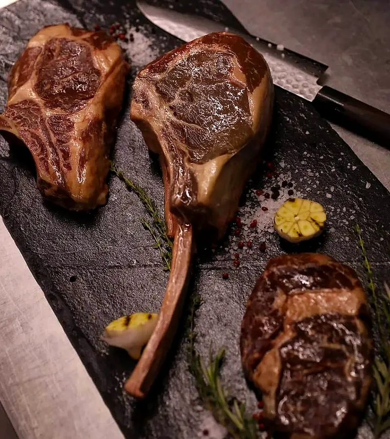 Steak-uri marmorate pe tocător, înainte de grill